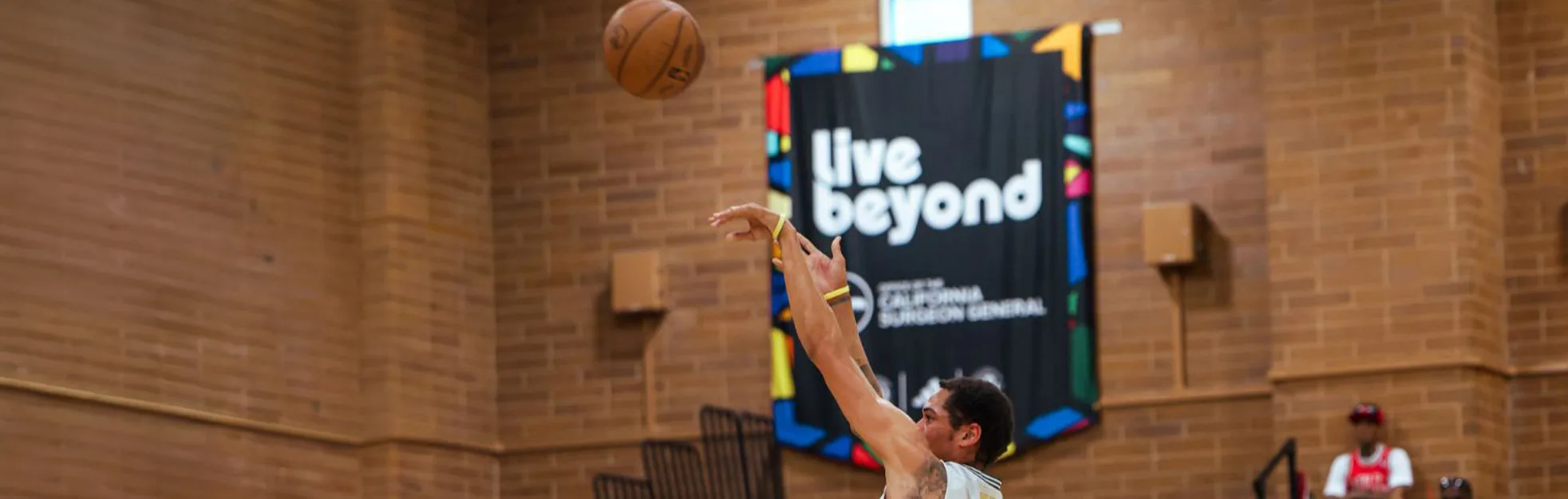 LiveBeyond banner on basketball court wall